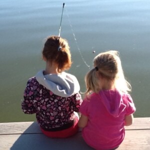 girls sitting on dock fishing - image