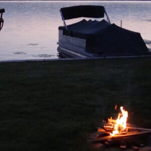 bonfire by lake - image